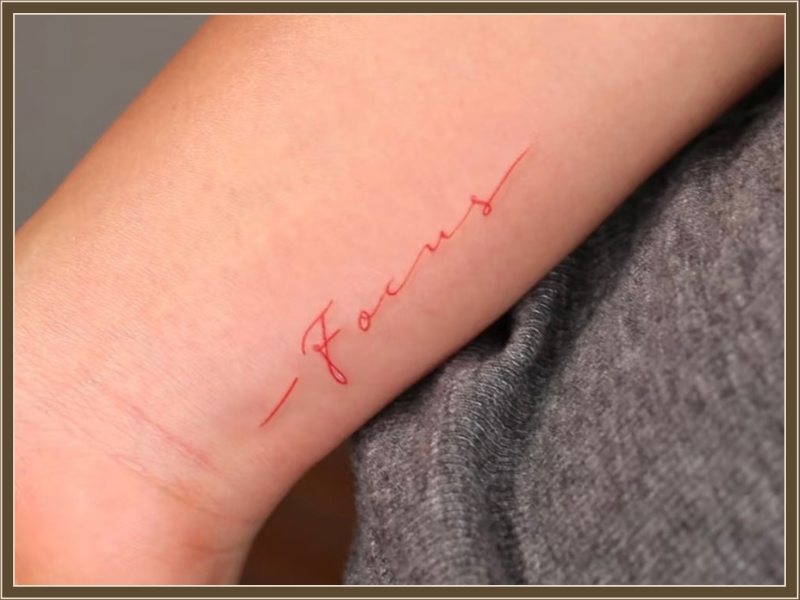 red text tattoo focus