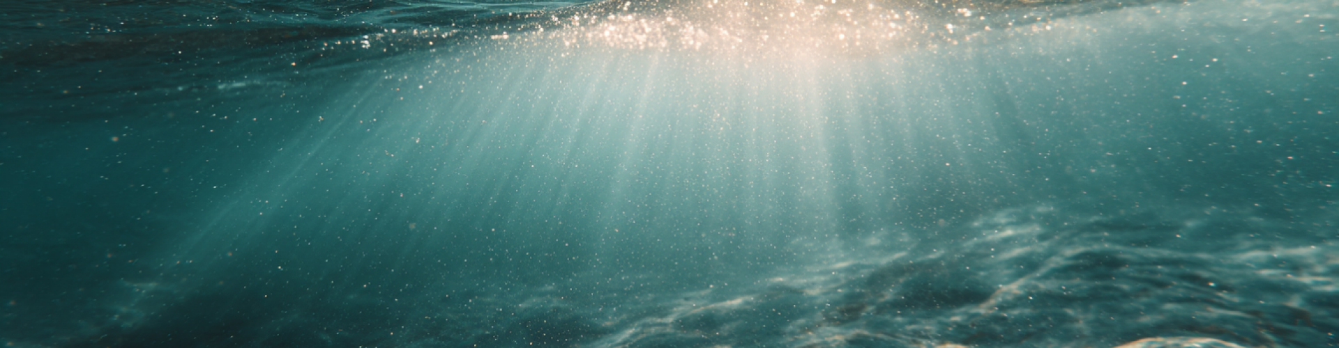 Zonlicht op zee tijdens energietransmissie Zon die deels in de zee schijnt, moment van rust en energetische afstemming