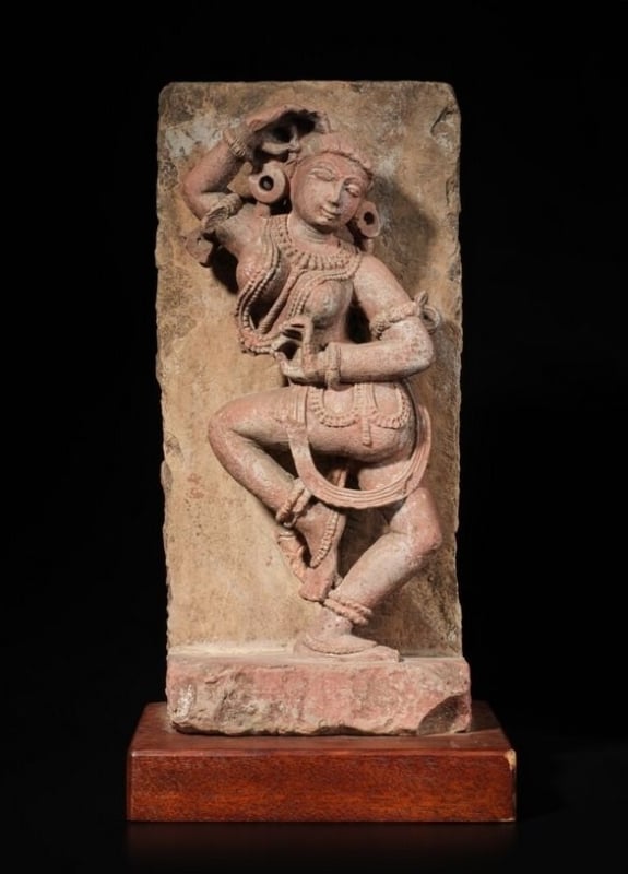 A mottled red sandstone figure of a dancing Yakshi, Rajasthan, circa 11th century