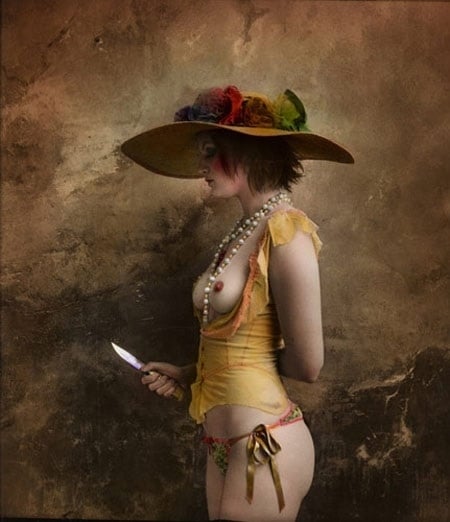 Jan Saudek semi nude female wearing a hat holding a knife