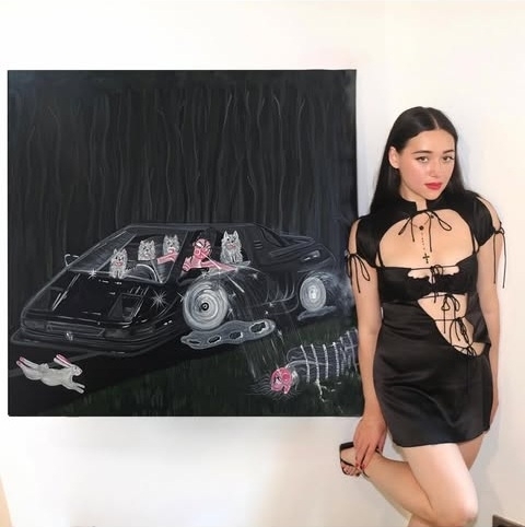Oh de Laval with her painting Unhappy People are Dangerous, acryl on canvas