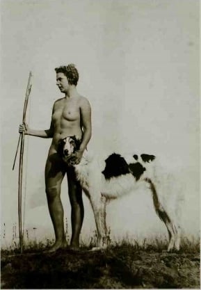 standing nude female with dog holding a bow and arrow