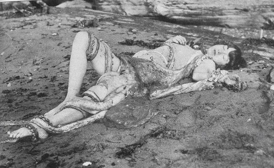 black and white photograph of an Asian girl lying on the beach with an octopus on top of her tentacle erotica - black and white photograph of an Asian girl lying on the beach with an octopus on top of her
