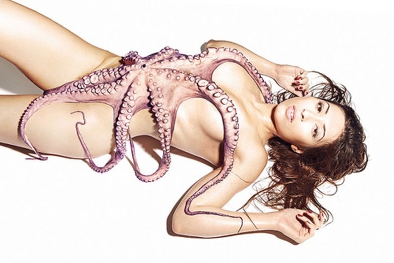 A lady lying on the floor with an octopus all over her