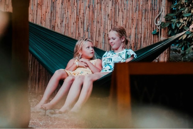 Children relaxing in a hammock at Familycamp Messanges