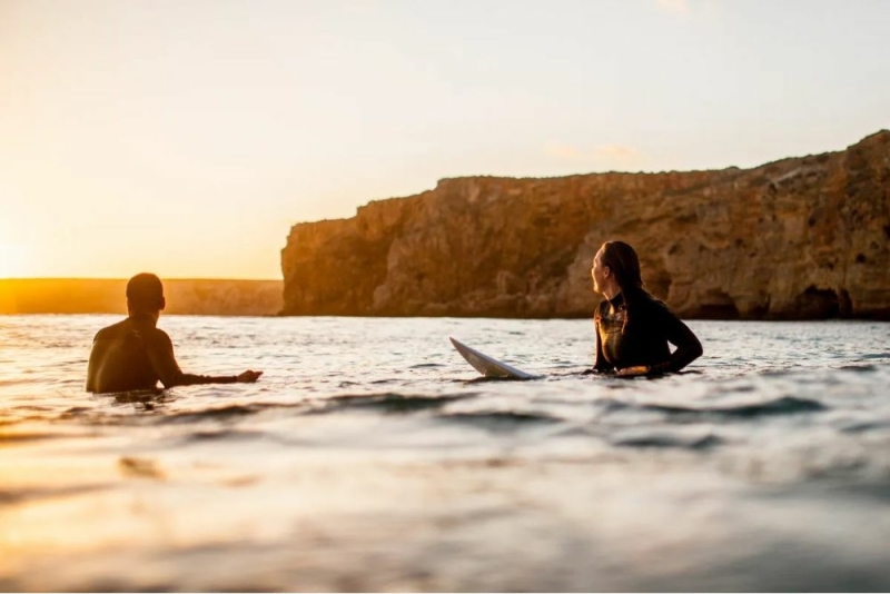 Surfer taking a lesson in mellow Algarve waves near Aljezur