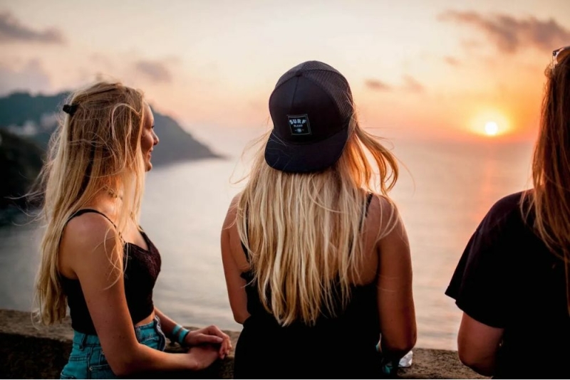 Friends relaxing on the beach at sunset in Moliets France