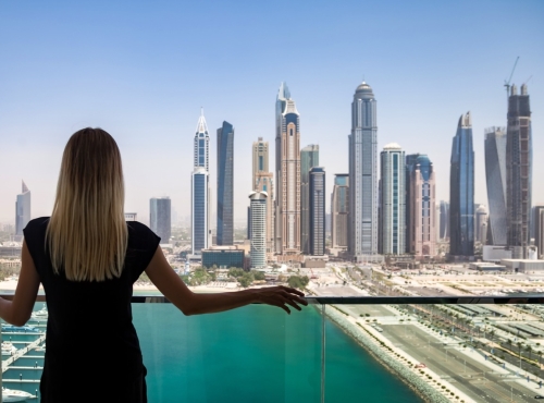 vrouw kijkt uit appartement naar dubai