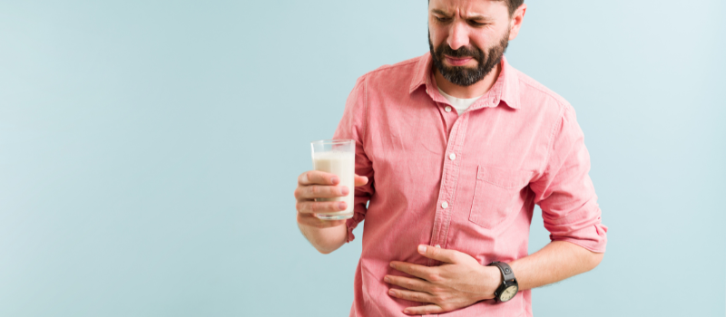 Man met buikpijn na melk drinken, mogelijk lactose-intolerantie