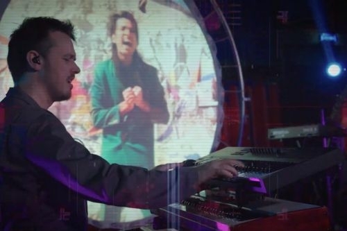 VoxTechnik LIVE synths on stage VoxTechnik LIVE synth player on stage with circular screen with videoclip in background