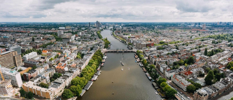 Drone view over the Amsterdam Amstel river and connecting neighborhoods